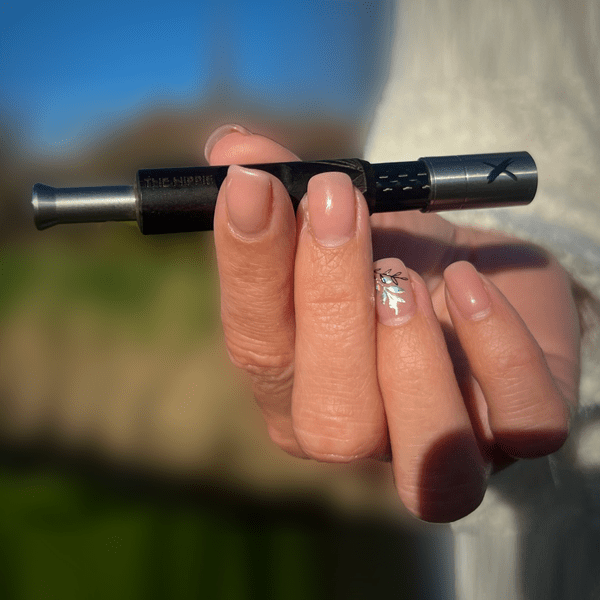 Black Pipe X analog vaporizer held horizontally in hand