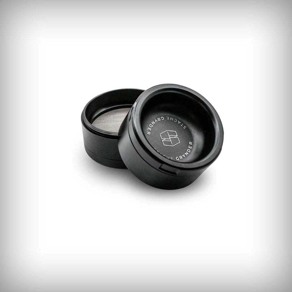 Black Stache Grynder open to show the interior collection chamber