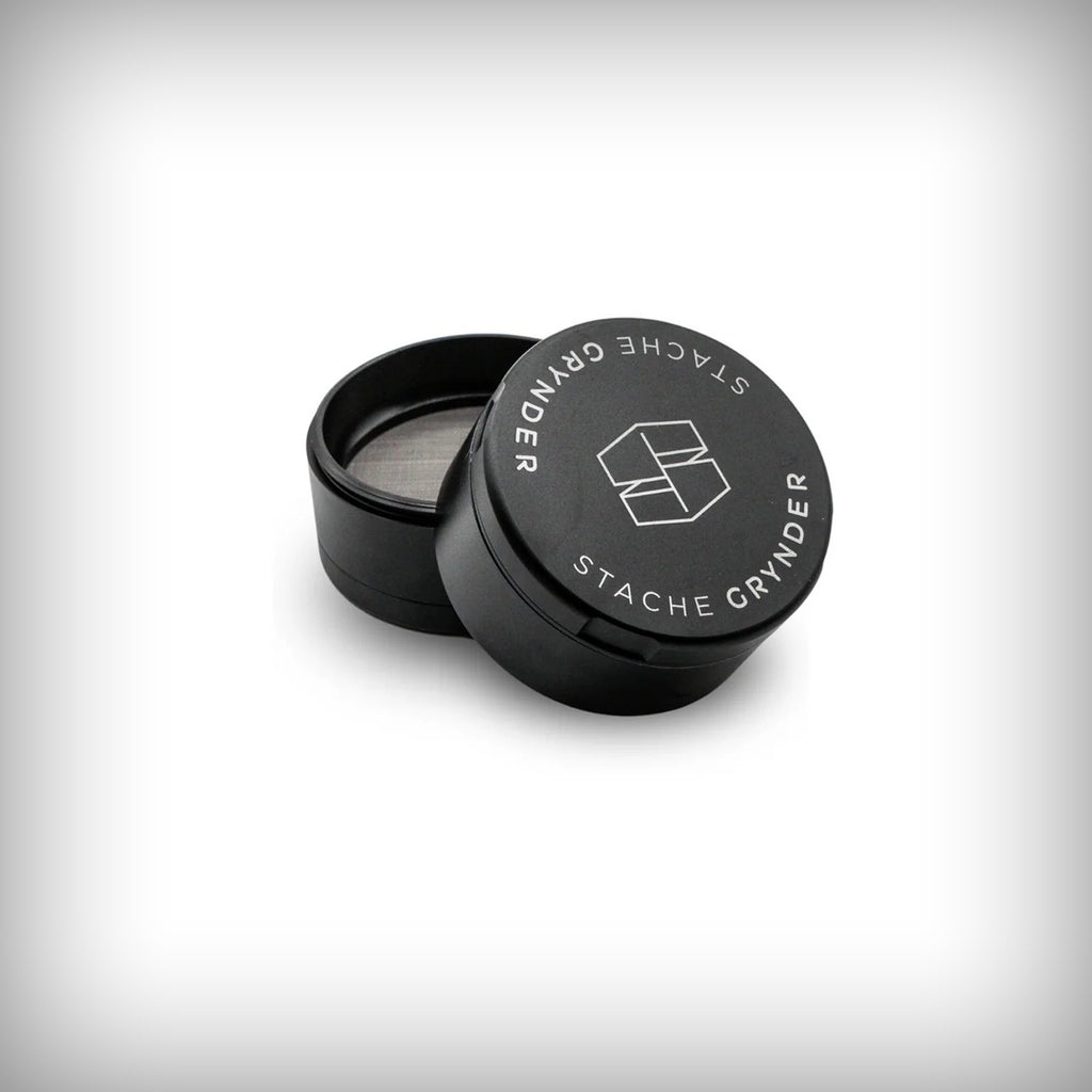 Black Stache Grynder partially open showing the upper chamber and lid