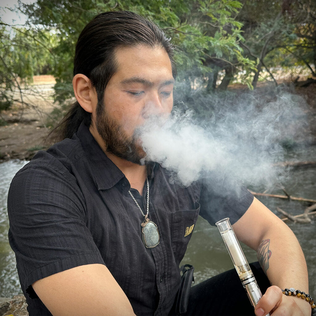 Cipher NOVA electric smoking pipe being used outdoors
