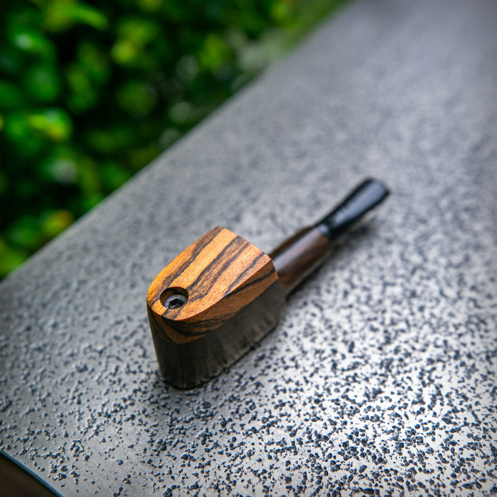 Close-up of The Mill Mup Capper wooden smoking pipe showing bowl and lid outdoors