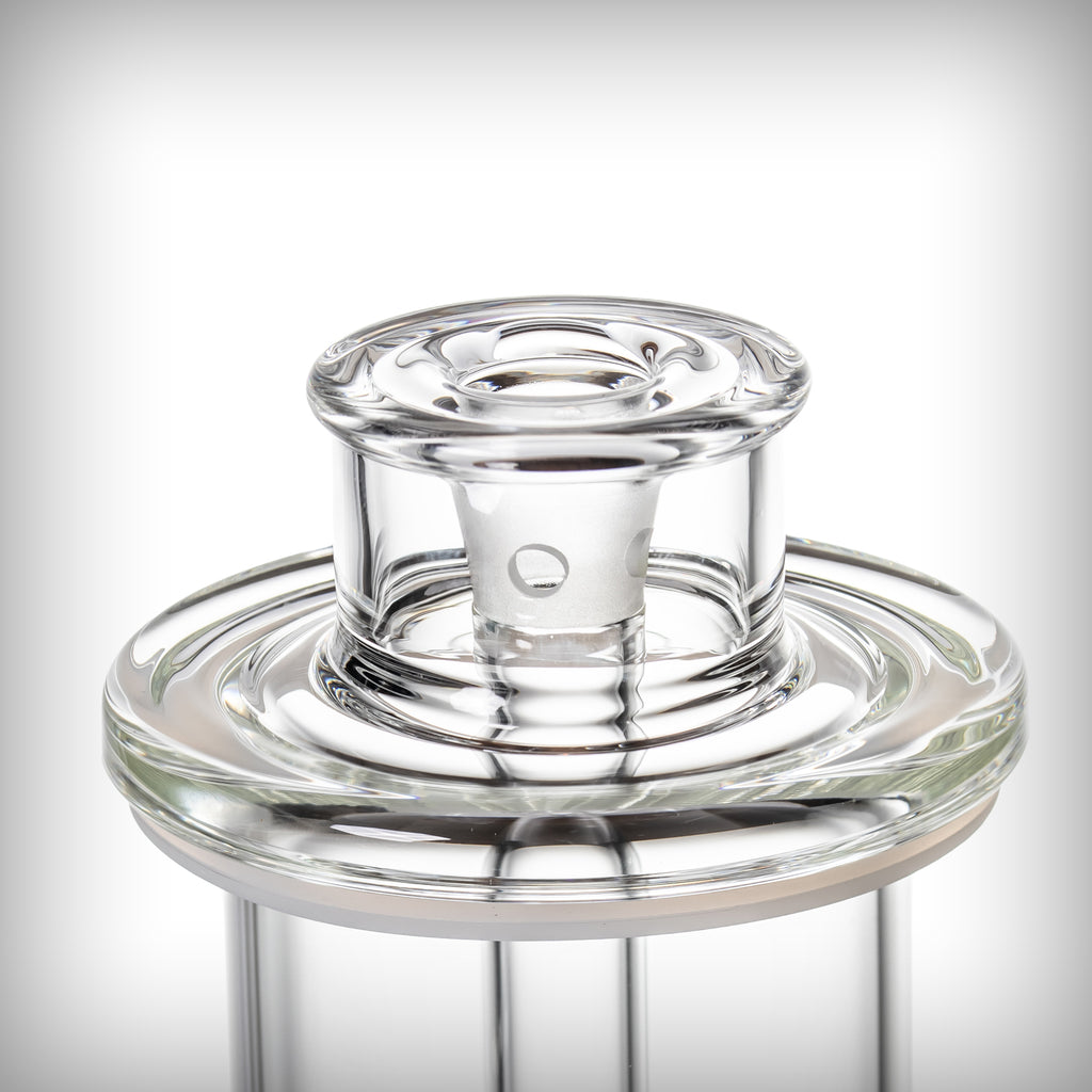 Close-up of the MJ Arsenal Piston Gravity Bong removable glass slide seated in the circular upper glass assembly.