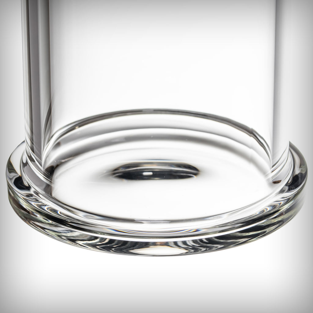 Close-up of the circular glass base of the MJ Arsenal Piston Gravity Bong showing its rounded rim and central opening.