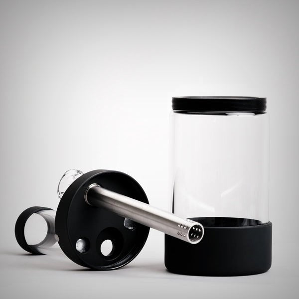Disassembled black Honest Capsule Water Pipe with stem and base components
