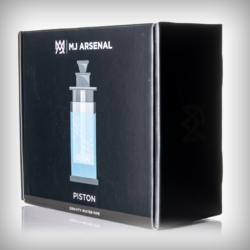 Front of the MJ Arsenal Piston Gravity Bong black retail box featuring the MJ Arsenal branding and product illustration.