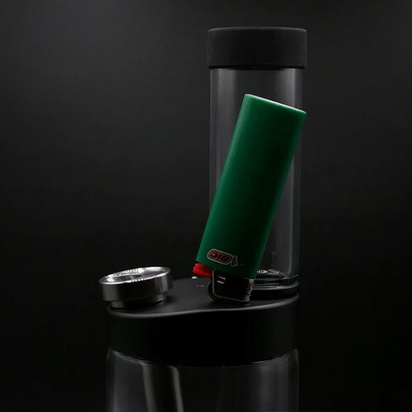 Green lighter held on the magnetic lid of an Honest Capsule Water Pipe