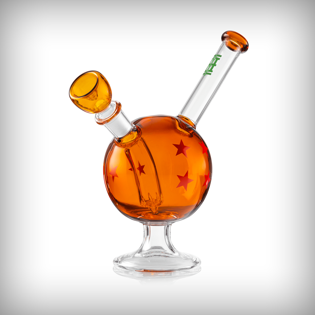 HEMPER Wish Ball water pipe side angle showing amber glass body, bowl, clear mouthpiece, and star graphics
