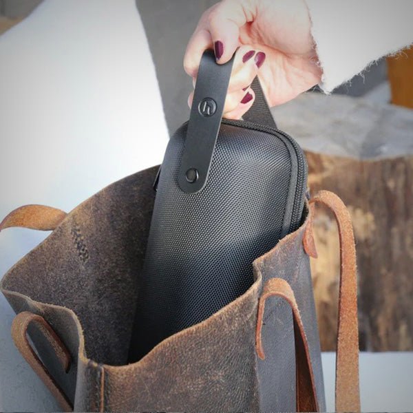 Honest Capsule Carry Case being placed inside a tote bag