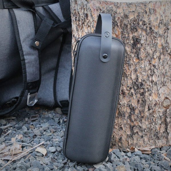 Honest Capsule Carry Case standing beside a backpack outdoors