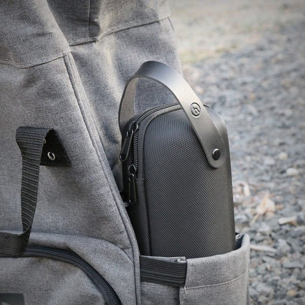 Honest Capsule Carry Case stored in an exterior bag pocket