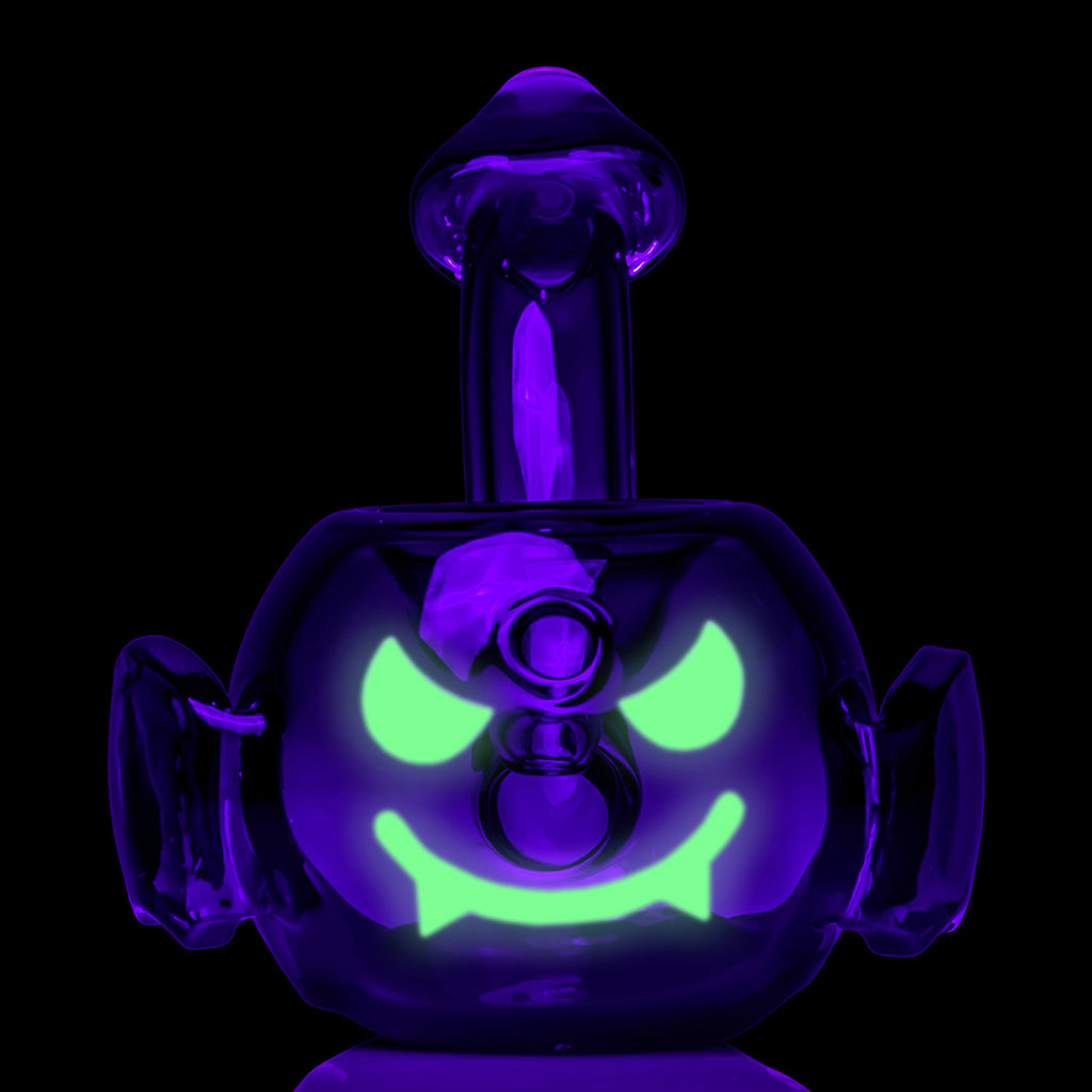 MJ Arsenal Bat Hand Pipe glowing in the dark with illuminated green facial details