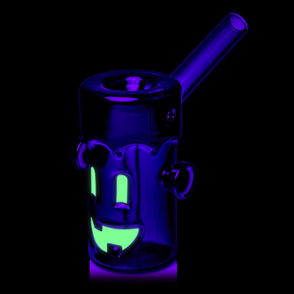 MJ Arsenal Frankenbubbler glowing under dark lighting with glass stem visible
