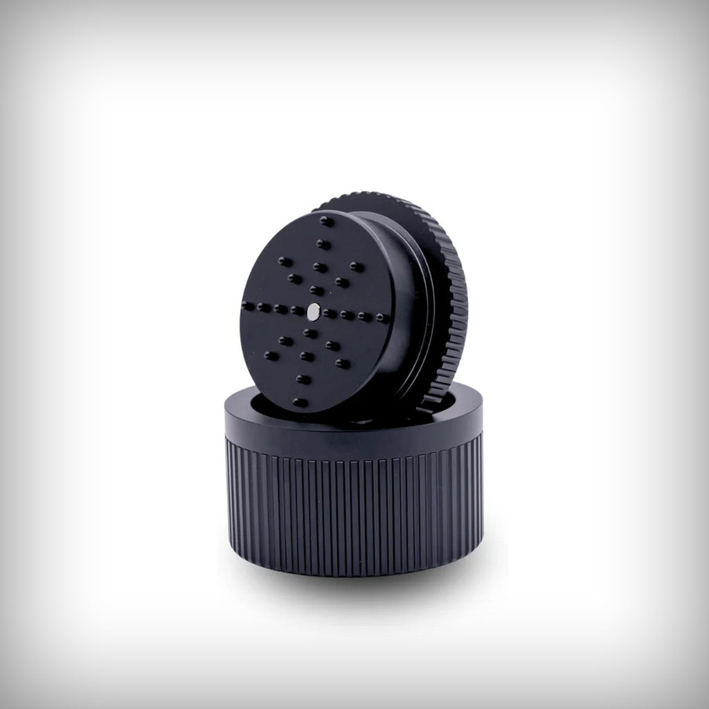 Open Stache Grynder 360 black grinder with lid and grinding chamber visible