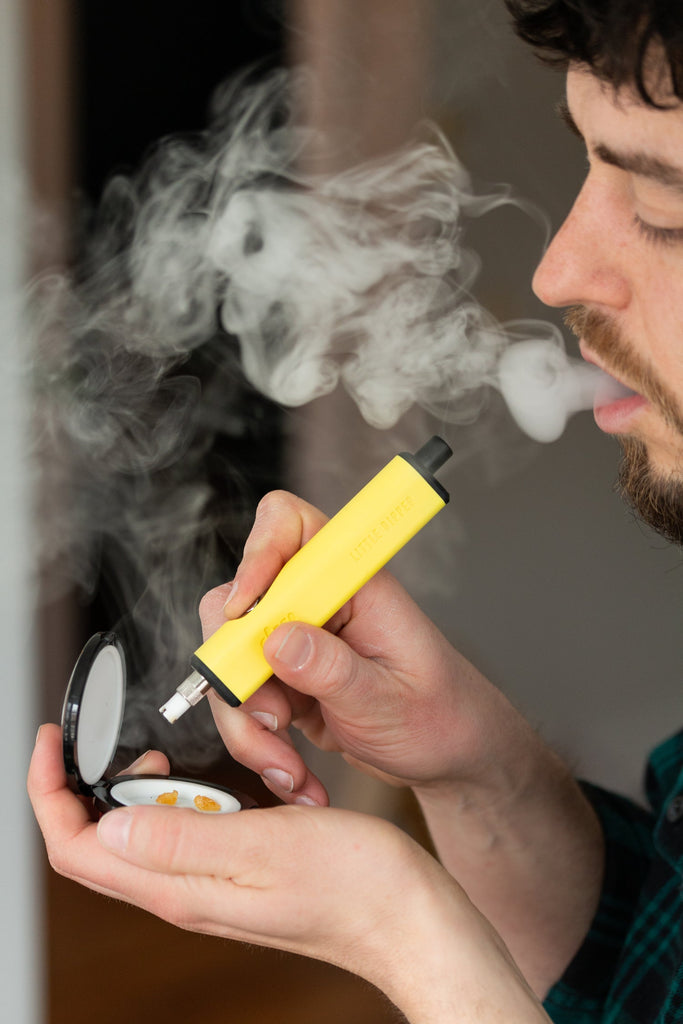 Person using yellow Dip Devices Little Dipper electric nectar collector