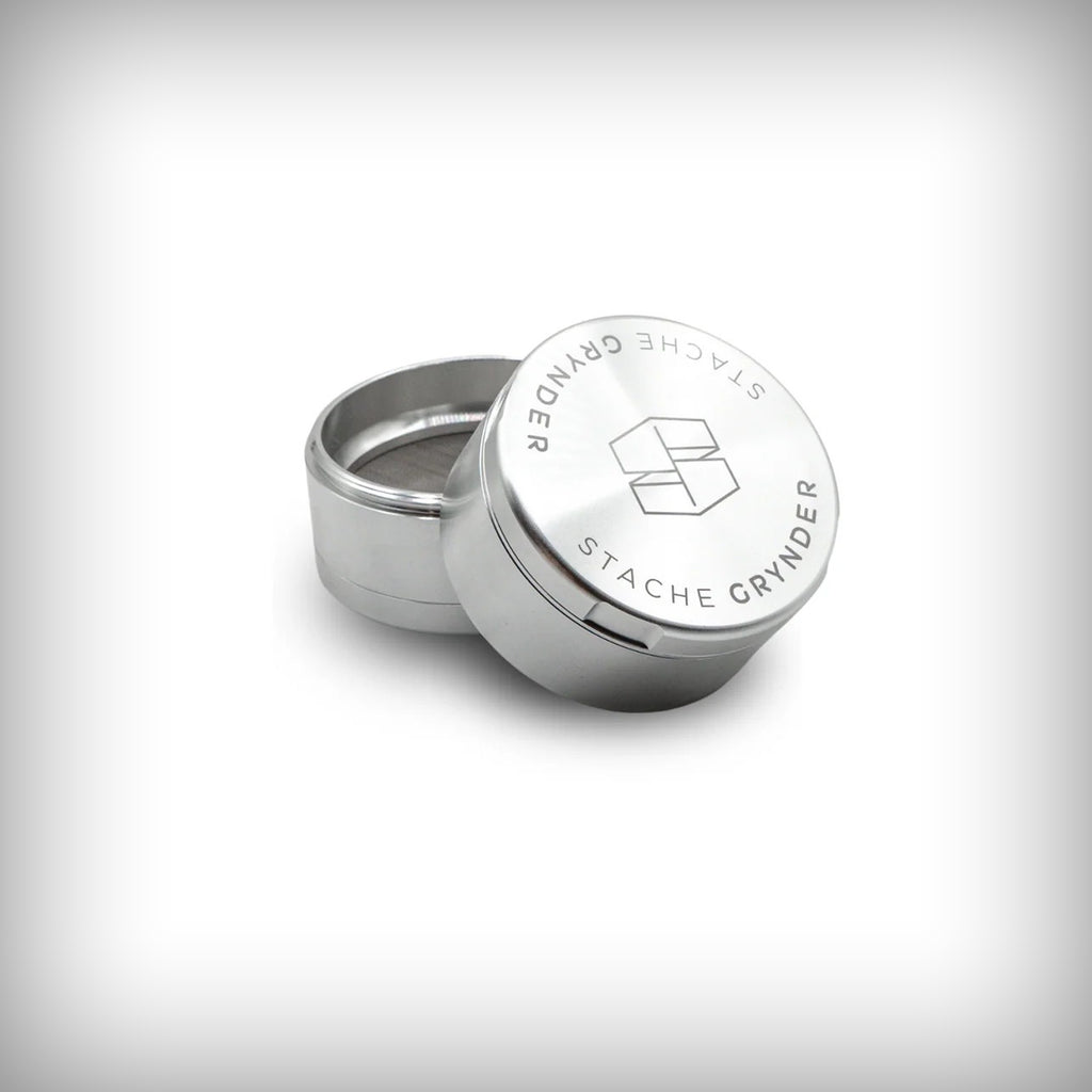 Silver Stache Grynder partially open showing the upper chamber and lid