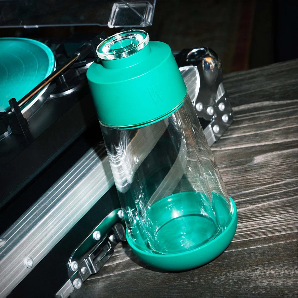 Weday Forest Gravity Bong beside a vinyl record player