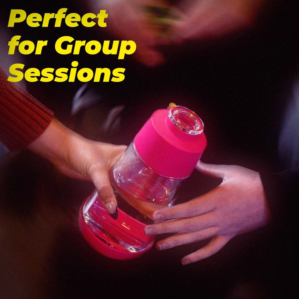 Weday Hot Pink Gravity Bong held in hand during a group-session lifestyle scene