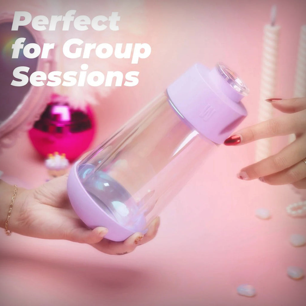 Weday Iridescent Lavender Gravity Bong held in hand during a group-session lifestyle scene