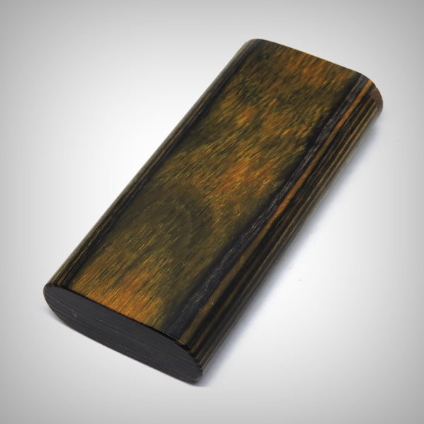 The Mill wooden dugout closed, showing dark wood panel and striped side grain